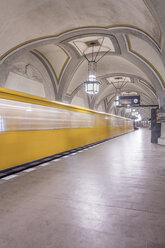 Germany, Berlin, historic subway station Heidelberger Platz with moving underground train - NKF000134