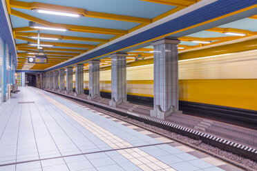 Germany, Berlin, subway station Lindauer Allee with moving underground train - NKF000140