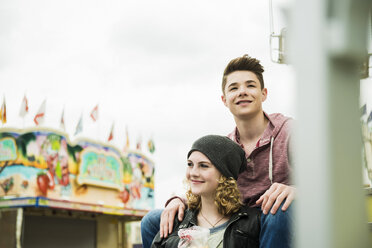 Portrait of happy teenage couple at fun fair - UUF000660