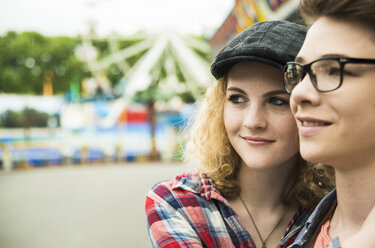 Portrait of happy teenage couple at fun fair - UUF000612