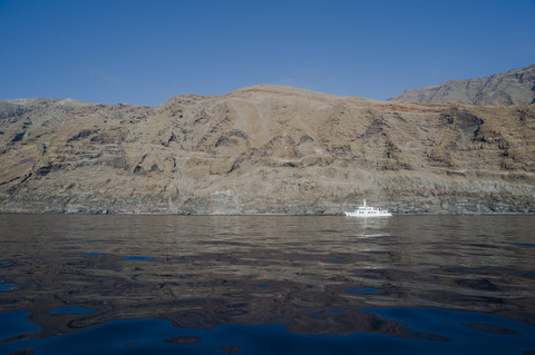 Mexico, Guadalupe, view to rocky coast with ship in front stock photo