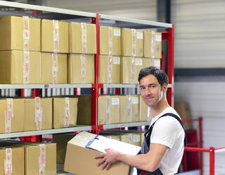 Portrait of smiling worker in warehouse - LYF000039