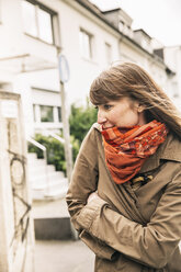 Portrait of freezing woman wearing orange scarf - MFF001105