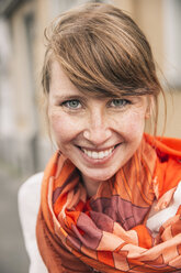 Portrait of smiling woman wearing orange scarf - MFF001104