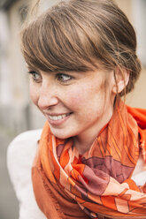 Portrait of smiling woman wearing orange scarf - MFF001103