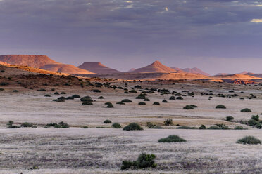 Africa, Namibia, Damaraland, view to grassland and volcanos by sunset - HLF000602