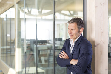 Portrait of happy business man with crossed arms - FKF000529