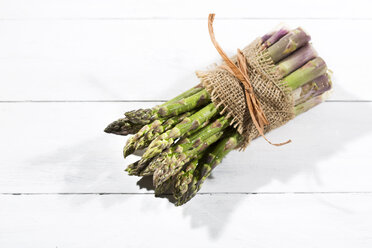Bunch of green asparagus on white wood, elevated view - MAEF008342