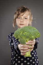 Portrait of little girl holding broccoli - OJF000026