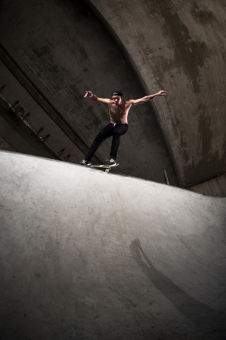 Skateboarder performing trick at skateboard park stock photo