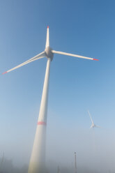 Germany, Hamburg, wind turbine in early morning fog - MSF003984