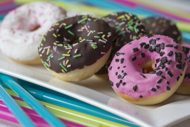 Plate of decorated doughnuts, close-up - YFF000149