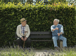 Germany, Worms, Two old friends sitting on bench in park - UUF000695