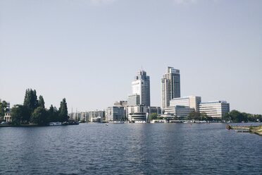 The Netherlands, Amsterdam, Amstel river with modern office buildings - HAWF000228