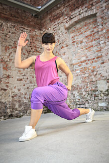Woman wearing sport dress dancing zumba or aerobics in gym - VTF000267