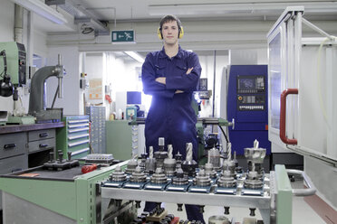 Germany, Young mechanic working in crafts workshop - SGF000750