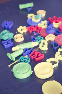 Many toy cutters lying on wooden table - LVF001414