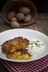 Potato fritters with quark and chives on plate - LVF001400