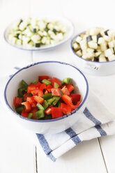 Schalen mit gewürfelten roten und grünen Paprikaschoten, Zucchini und Auberginen auf weißem Holz - EVGF000612