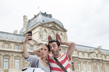 Frankreich, Paris, Pärchen fotografiert sich selbst mit Smartphone - FMKF001330