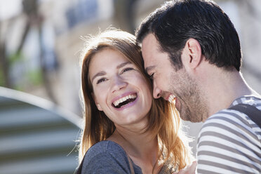 France, Paris, portrait of happy couple having fun - FMKF001345