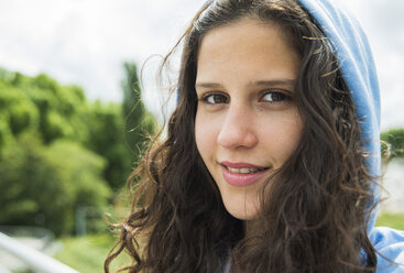 Portrait of smiling young woman with hood - UUF000959