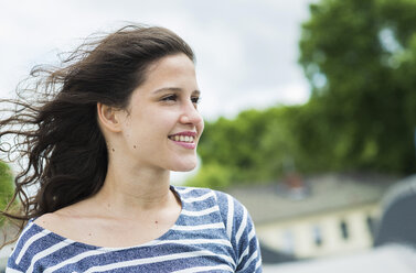 Portrait of smiling young woman with blowing hair - UUF000967