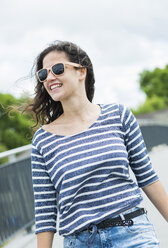 Portrait of smiling young woman wearing sunglasses - UUF000968