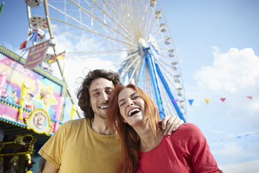 Happy young couple on a funfair - RHF000368