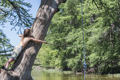 USA, Texas, Boy with stick at Frio River - ABAF001413