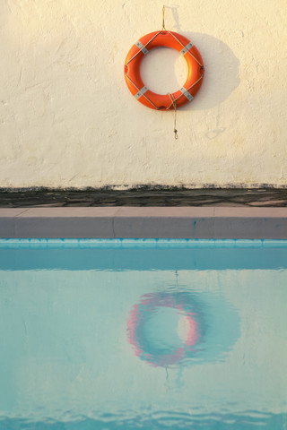 Spain, Canary Islands, La Palma, life saver hanging on wall behind swimming pool stock photo