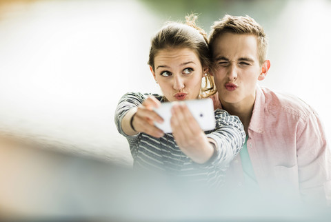 Young couple taking a selfie with smartphone stock photo