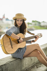 Portrait of teenage girl playing guitar - UUF001028