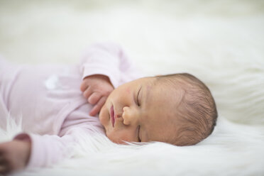 Neugeborenes Mädchen schläft auf einem Schafsfell - ROMF000013