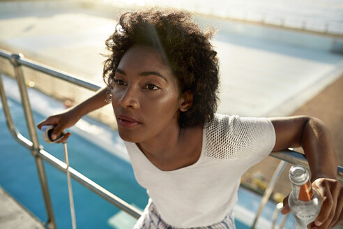 Young woman on highboard of swimming pool - VV000124