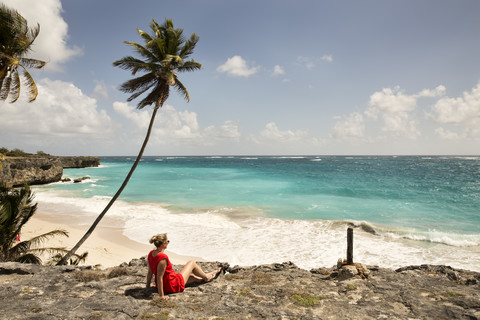 Caribbean, Barbados, Bottom Bay, woman sitting at the coast stock photo