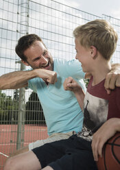 Germany, Mannheim, Father and son cheering - UUF001100