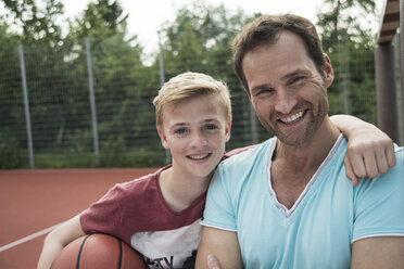 Germany, Mannheim, Father and son playing basket ball - UUF001181