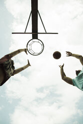 Germany, Mannheim, Father and son playing basket ball - UUF001179