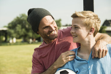 Germany, Mannheim, Father and son playing soccer - UUF001117