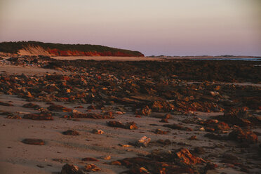 Australia, Western Australia, Sunset on a rock and sand beach near Broome - MBEF001028