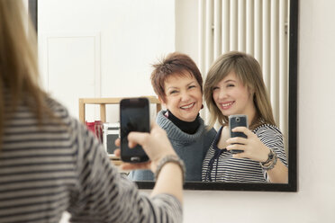 Germany, Berlin, Mother and daughter photographing selves - MMFF000021