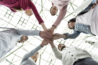 Group of young people stacking their hands - WESTF019764