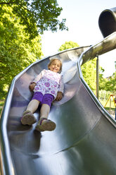 Little girl sliding on shute - JFEF000412