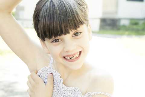 Portrait of smiling little girl with tooth gap making a face stock photo