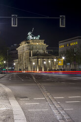 Deutschland, Berlin, Brandenburger Tor bei Nacht, die Kopfsteinpflasterlinie markiert die ehemalige Position der Berliner Mauer - NKF000149