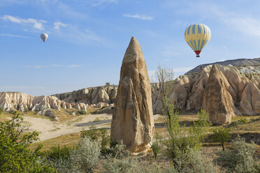 Turkey, Cappadocia, two hot air balloons hoovering over tuff rock formations at Goereme National Park - SIEF005531