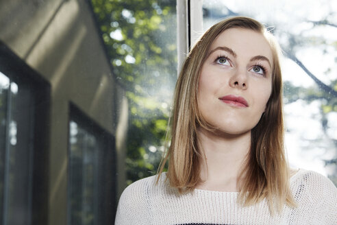 Woman at a window thinking - STKF000901