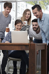 Group of creative professionals with laptop at table - STKF000966