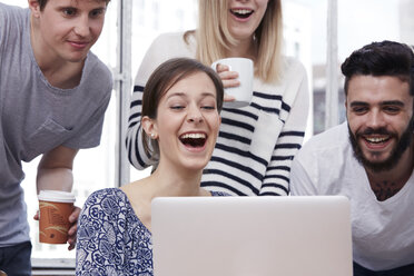 Group of creative professionals with laptop at table - STKF000968